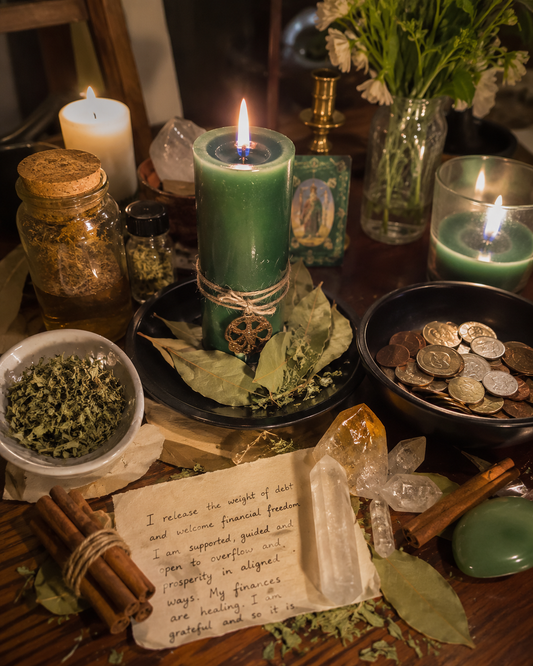 Get Out of Debt Spell altar ritual with green candle, coins, bay leaves, cinnamon sticks, herbs, crystals, and financial freedom petition.