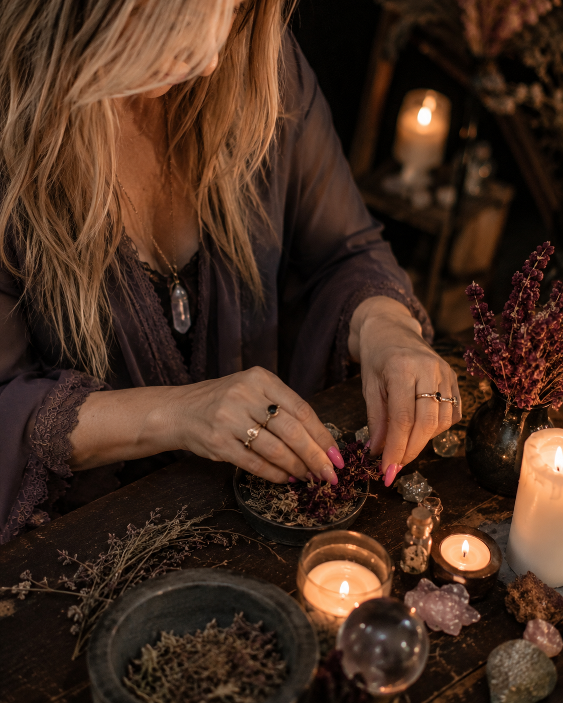 Belinda preparing herbs and candles for a Blockbuster Road Opener Spell at a private candlelit ritual altar with warm spiritual energy.