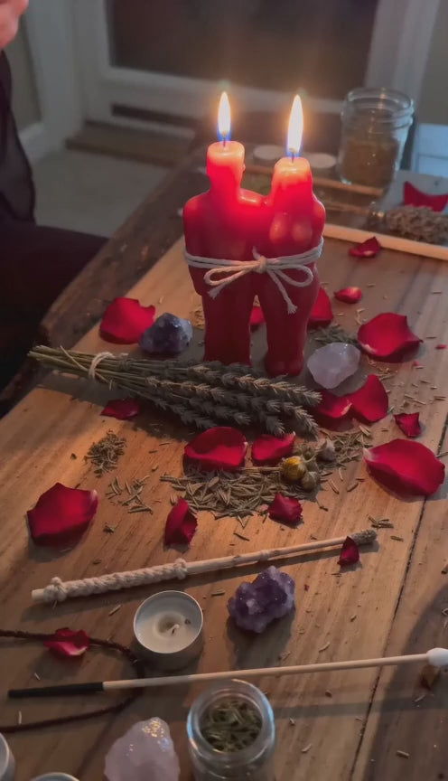 video of Belinda performing a Get Your Ex Back Spell with two red figure candles tied together, rose petals, herbs, crystals, and a private reconciliation ritual altar.
