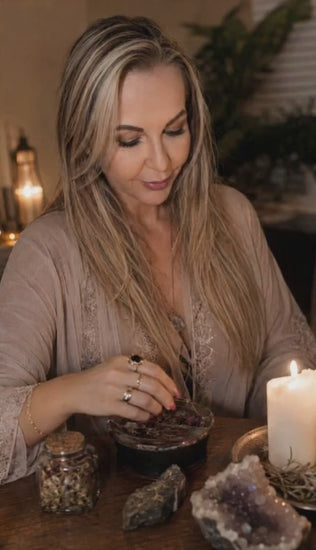 Belinda preparing a Forgiveness Spell ritual with candles, herbs, crystals, and spiritual tools to support emotional healing, reconciliation, forgiveness, and relationship restoration.