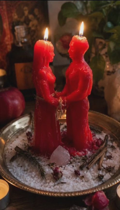 Cinematic video showing a Reuniting Love Spell ritual by Belinda at We Love Spells. The video begins with a red couple-figure candle on a bed of white salt, where Belinda’s hands gently tie a red silk cord around the figures and sprinkle dried roses and cinnamon sticks. The scene is softly lit by warm candlelight, capturing an intimate and peaceful spiritual atmosphere for relationship healing and reconnection.