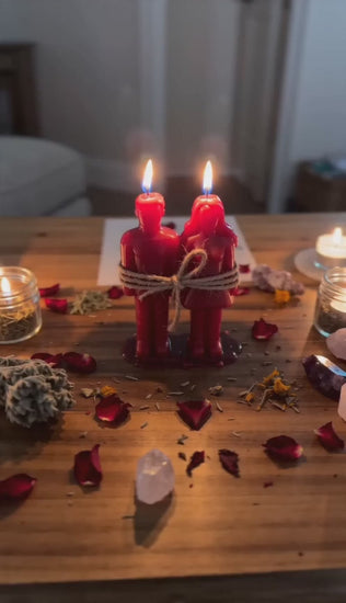Private Love Binding Spell video showing Belinda’s hands preparing a candle ritual with red bound candles, herbs and a petition for commitment, loyalty and emotional connection