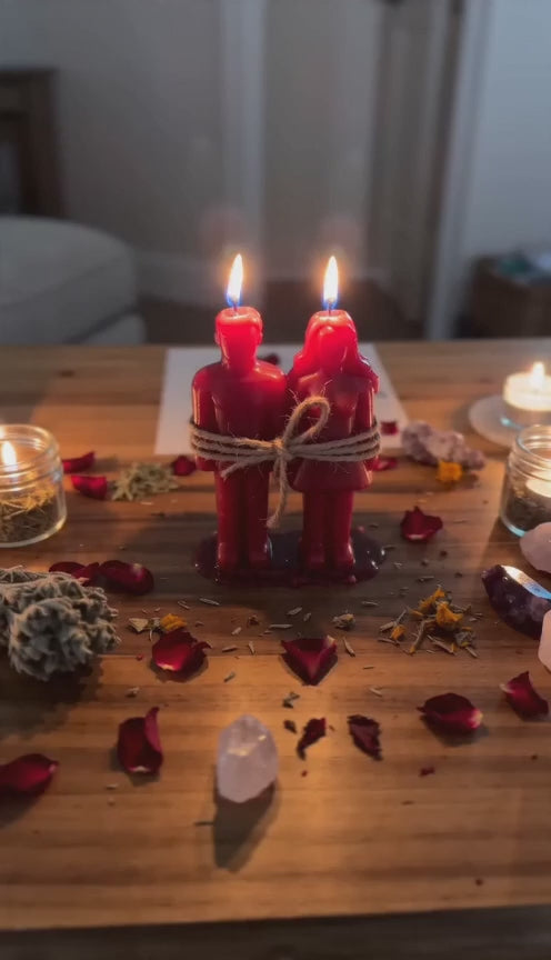 Private Love Binding Spell video showing Belinda’s hands preparing a candle ritual with red bound candles, herbs and a petition for commitment, loyalty and emotional connection