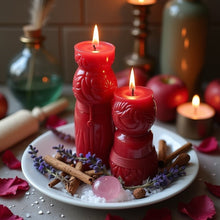 Load image into Gallery viewer, Two lit red figure candles on a plate with cinnamon sticks, lavender, rose petals, and rose quartz used for a Reuniting Love Spell ritual.